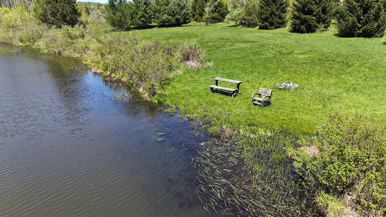 3392 Eminence Road Hancock, NY 12760 - Photo 23 of 43 a view of a lake with a yard