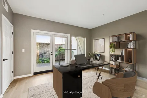 a living room with furniture and a floor to ceiling window