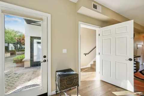 a view of a hallway view with wooden floor and staircase