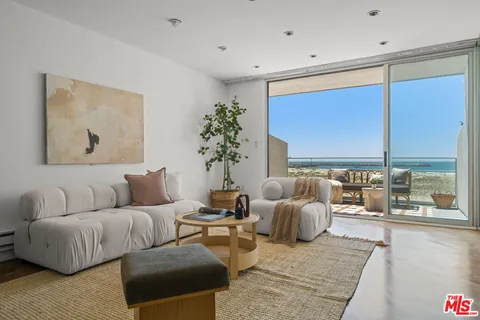 a living room with furniture and large windows