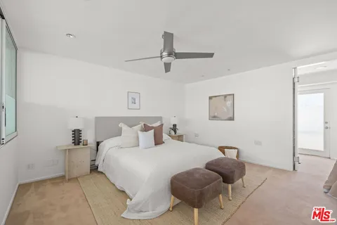 a bedroom with a bed and ceiling fan