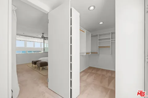 a view of hallway with livingroom and furniture
