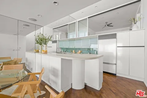 a kitchen with stainless steel appliances granite countertop a refrigerator and a stove top oven