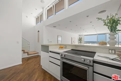 a kitchen with a stove and a white cabinets