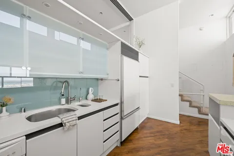a kitchen with a sink and cabinets