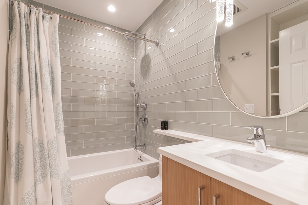 50 Rutland Square, Unit 1 Boston, MA 02118 - Photo 11 of 12 a bathroom with a granite countertop sink toilet and shower