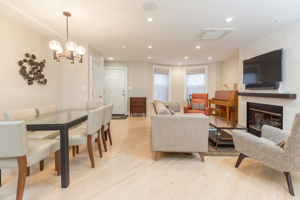 50 Rutland Square, Unit 1 Boston, MA 02118 - Photo 3 of 12 a living room with furniture a flat screen tv and a fireplace