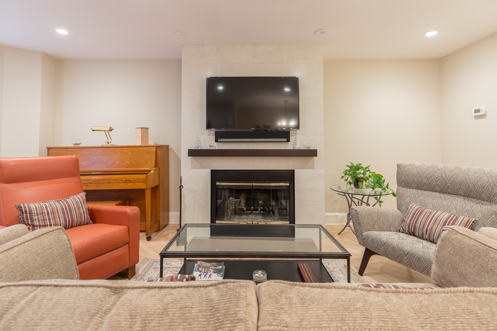 50 Rutland Square, Unit 1 Boston, MA 02118 - Photo 4 of 12 a living room with furniture a flat screen tv and a fireplace