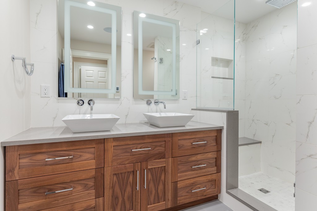 50 Rutland Square, Unit 1 Boston, MA 02118 - Photo 8 of 12 a bathroom with a sink a vanity a large mirror and shower