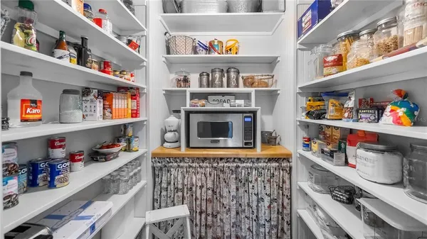 a room with fridge and a rug