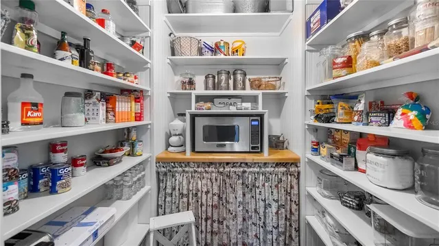a room with fridge and a rug