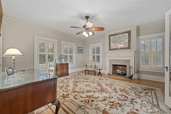 a living room with fireplace furniture and a table