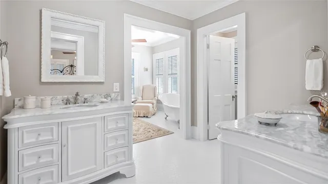 a spacious bathroom with a granite countertop sink and a mirror