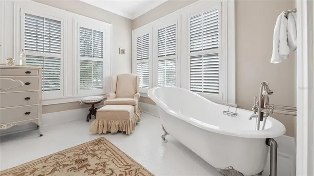 a spacious bedroom with a bed and a chair