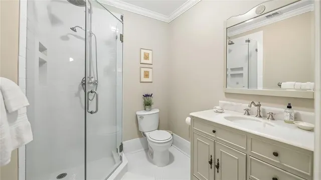 a bathroom with a toilet sink shower and mirror