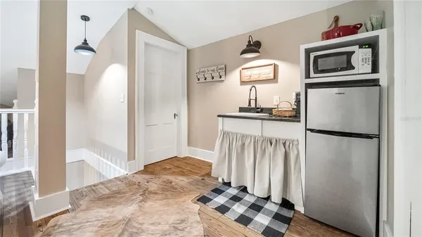 a kitchen with a refrigerator and a stove