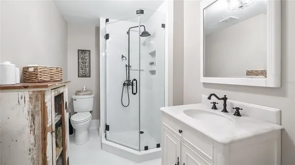 a bathroom with a sink vanity mirror and toilet