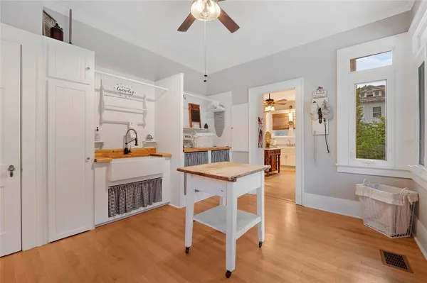 a kitchen with white cabinets and chair