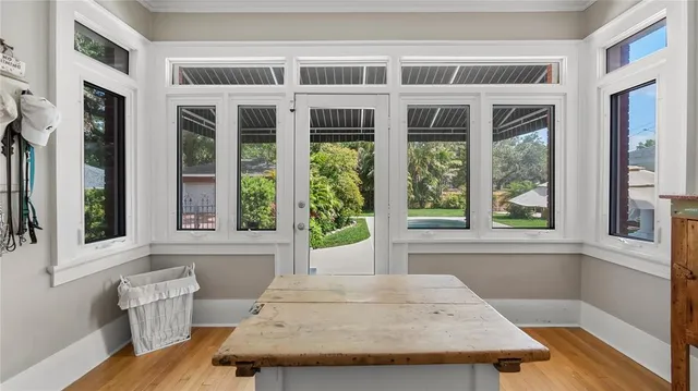 a view of a dining room with a table and windows