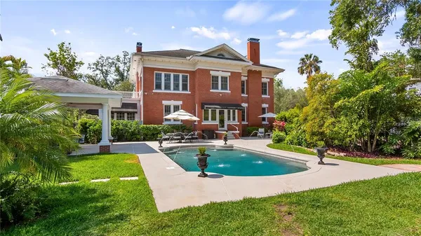 a view of a house with swimming pool and sitting area
