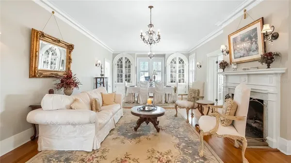 a living room with fireplace furniture and a chandelier