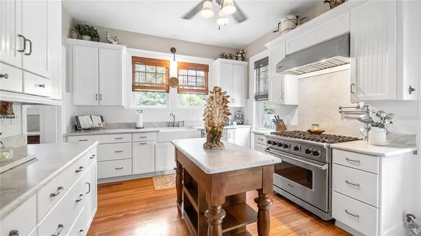 a kitchen with stainless steel appliances a stove sink and cabinets