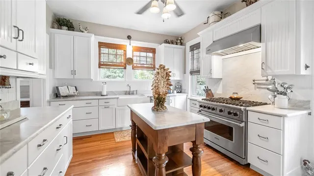 a kitchen with stainless steel appliances a stove sink and cabinets