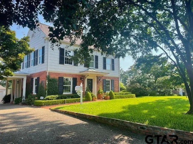 a view of a white house with a large pool