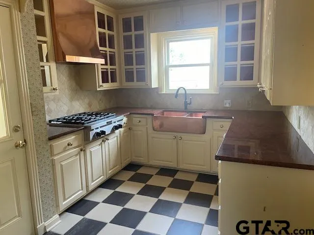 a kitchen with granite countertop stainless steel appliances a sink and cabinets