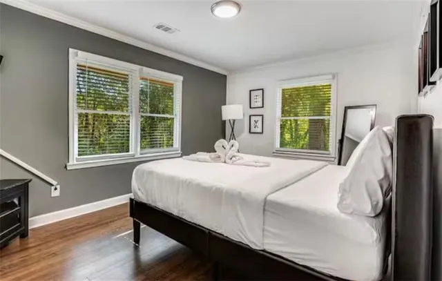 a bedroom with a bed and a night stand