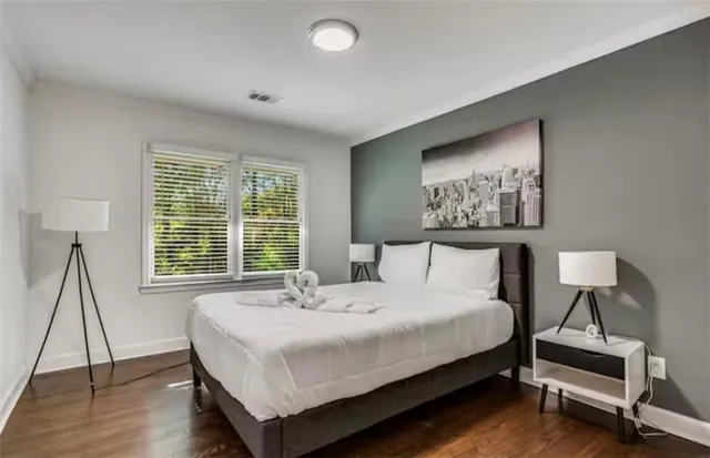 a living room with furniture flat screen tv and wooden floor