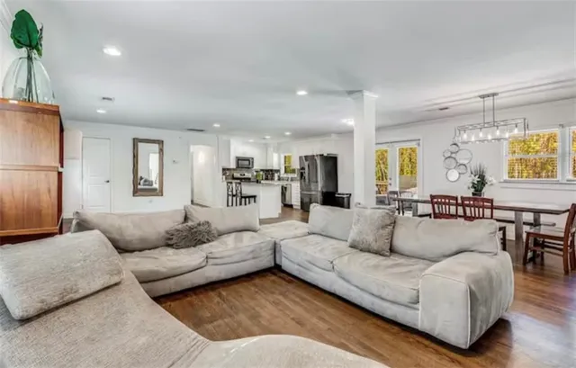 a living room with fireplace furniture and a wooden floor