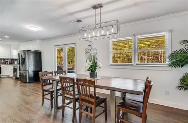 a kitchen with stainless steel appliances granite countertop sink stove and wooden floor