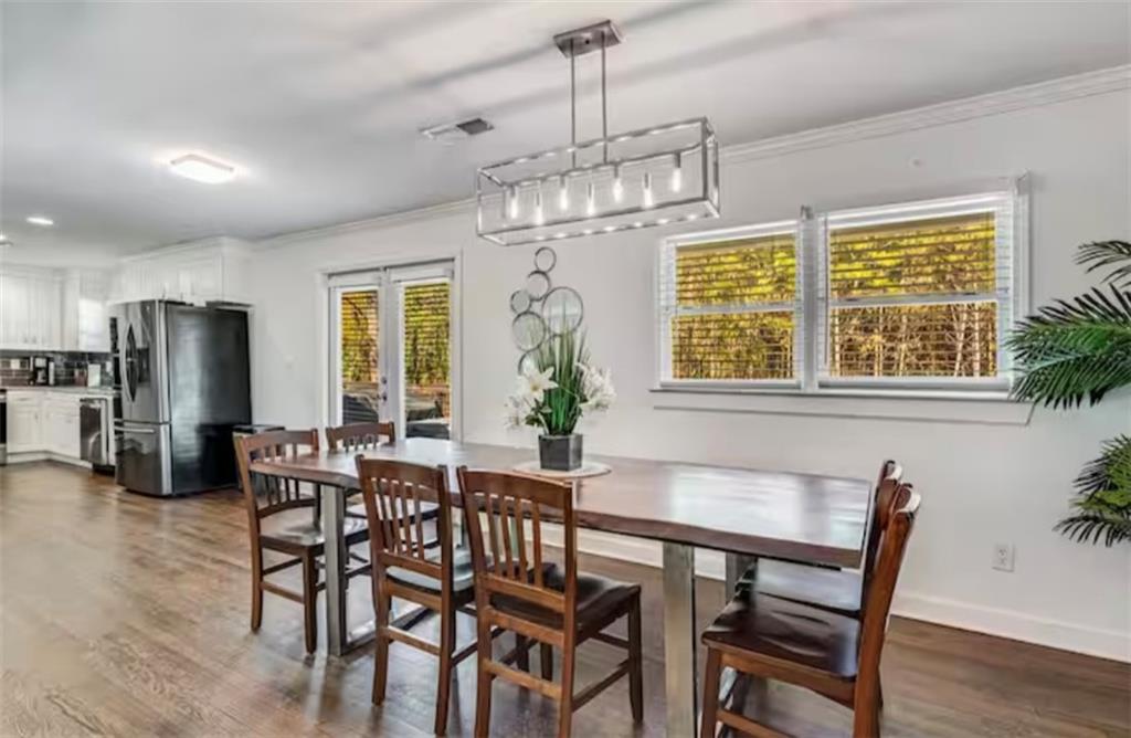 4050 Washington Road East Point, GA 30344 - Photo 25 of 58 a dining room with furniture a chandelier and wooden floor