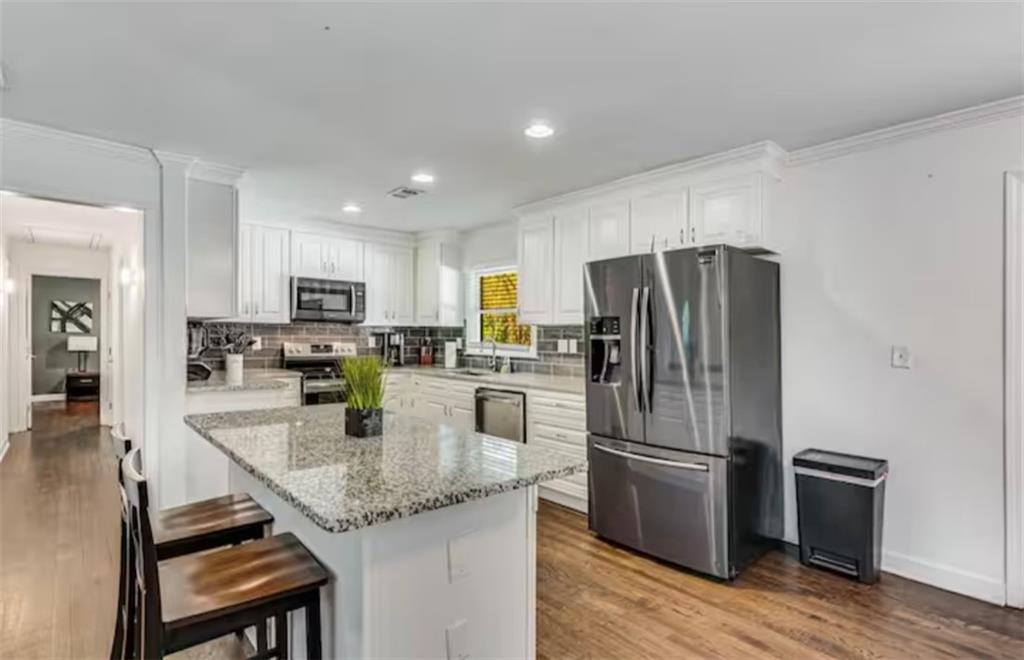 4050 Washington Road East Point, GA 30344 - Photo 26 of 58 a kitchen with stainless steel appliances granite countertop a refrigerator stove microwave and sink