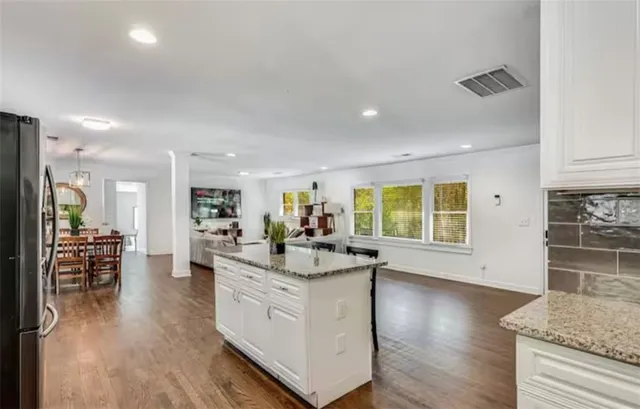 a kitchen with stainless steel appliances granite countertop a stove and a sink