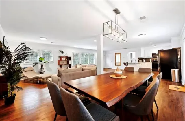 a living room with furniture a flat screen tv and a large window