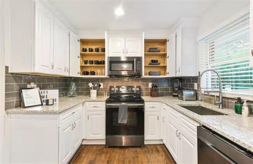 4050 Washington Road East Point, GA 30344 - Photo 33 of 58 a kitchen with stainless steel appliances granite countertop a stove and a sink