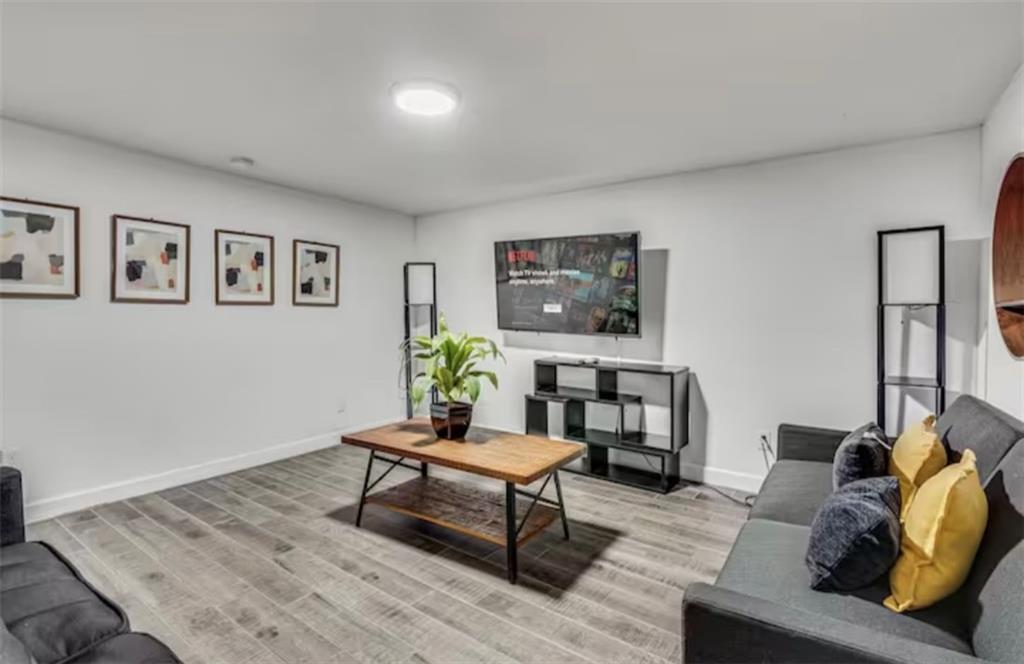 4050 Washington Road East Point, GA 30344 - Photo 38 of 58 a living room with furniture and a wooden floor