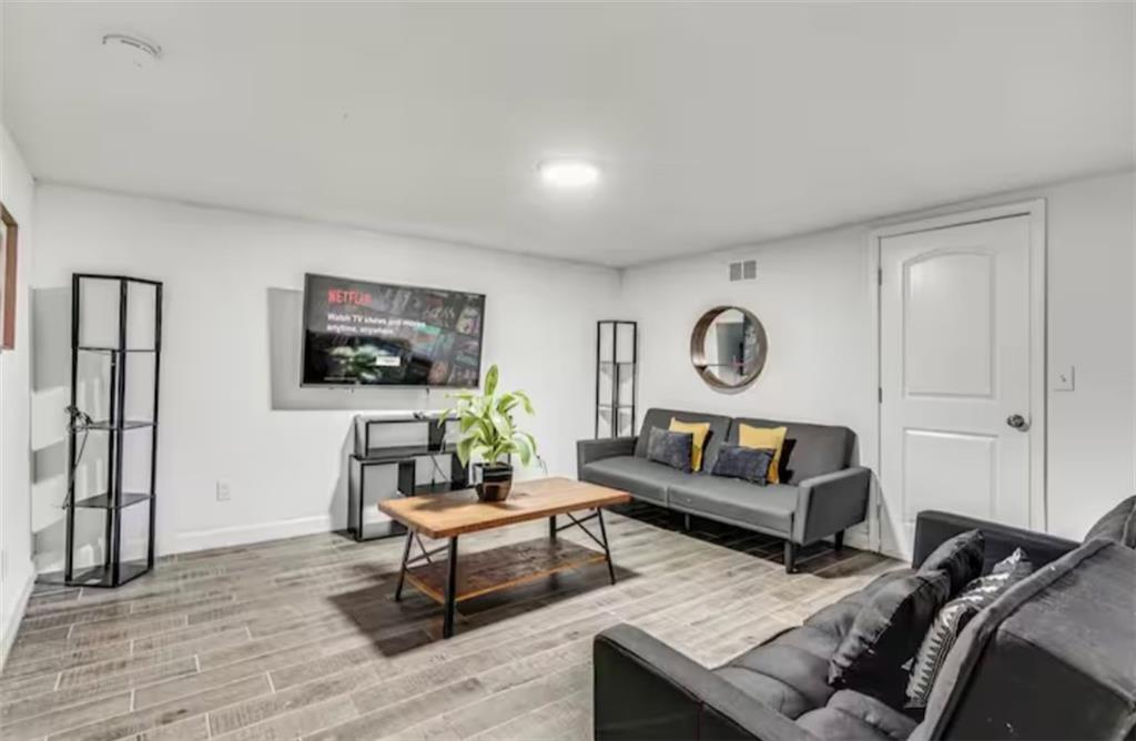 4050 Washington Road East Point, GA 30344 - Photo 39 of 58 a living room with furniture and a wooden floor