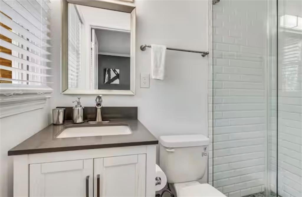4050 Washington Road East Point, GA 30344 - Photo 49 of 58 a bathroom with a sink toilet vanity and mirror