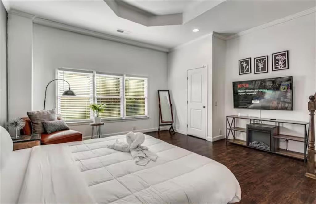 4050 Washington Road East Point, GA 30344 - Photo 10 of 58 a spacious bedroom with a large bed and a couch