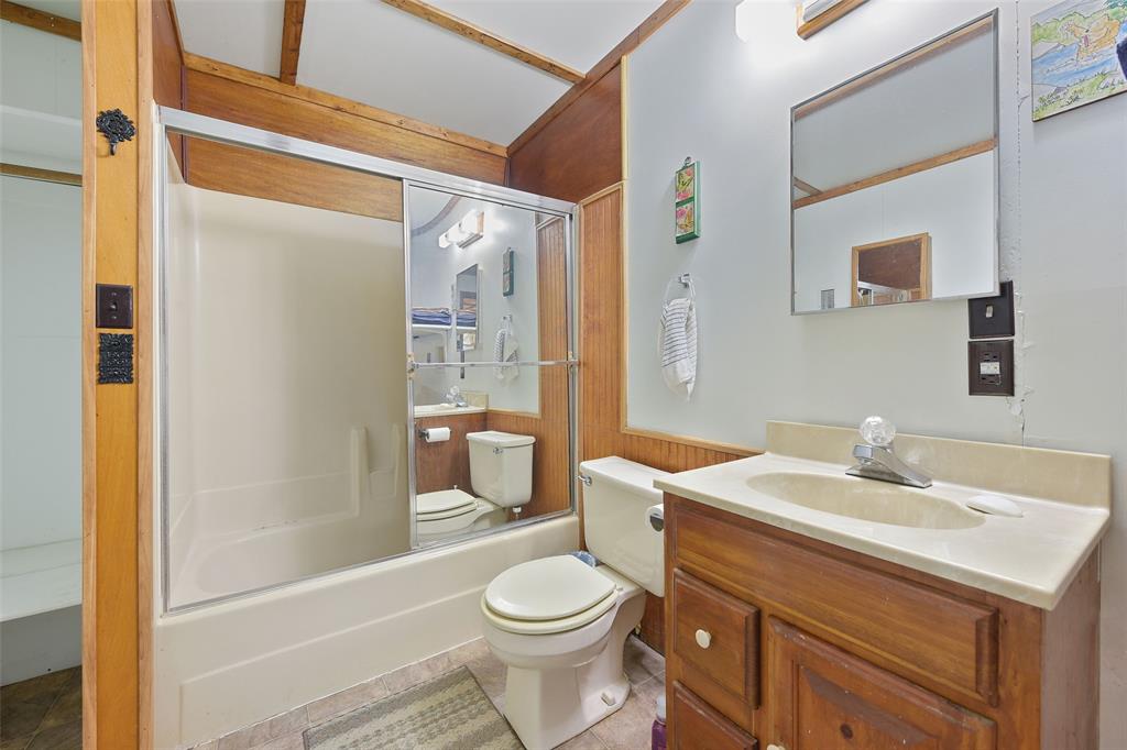 821 Ewing Road Ferris, TX 75125 - Photo 31 of 40 a bathroom with a sink toilet and shower