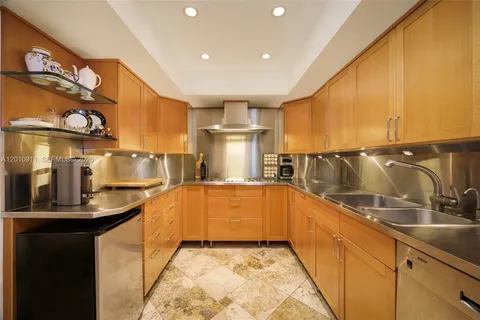 a kitchen with stainless steel appliances granite countertop a sink and cabinets