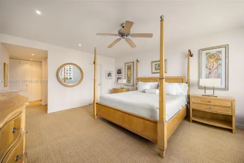 a spacious bedroom with a bed and a chandelier