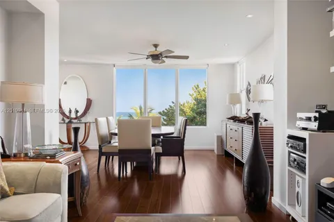 a view of a a dining room with furniture window and wooden floor