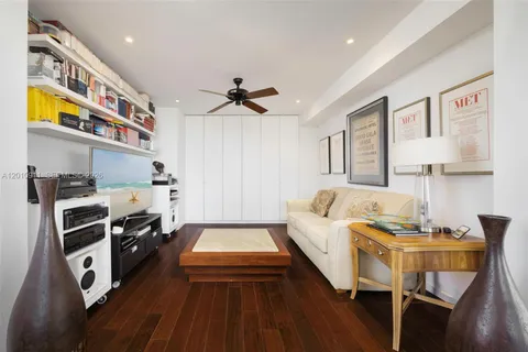 a kitchen with stainless steel appliances granite countertop a stove top oven a sink a dining table and chairs with wooden floor