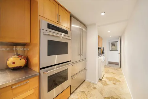 a kitchen with a sink and stainless steel appliances