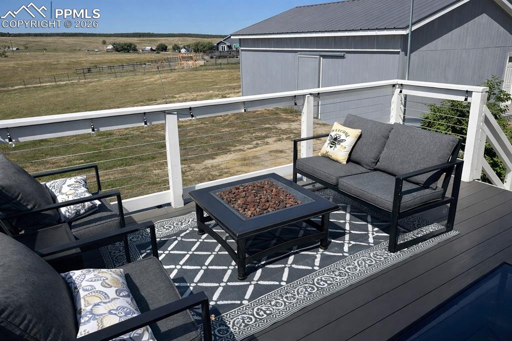 12285 Old Barn Road Elbert, CO 80106 - Photo 11 of 39 a balcony with table and chairs