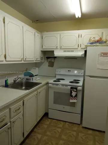 a kitchen with stainless steel appliances granite countertop a sink and a stove